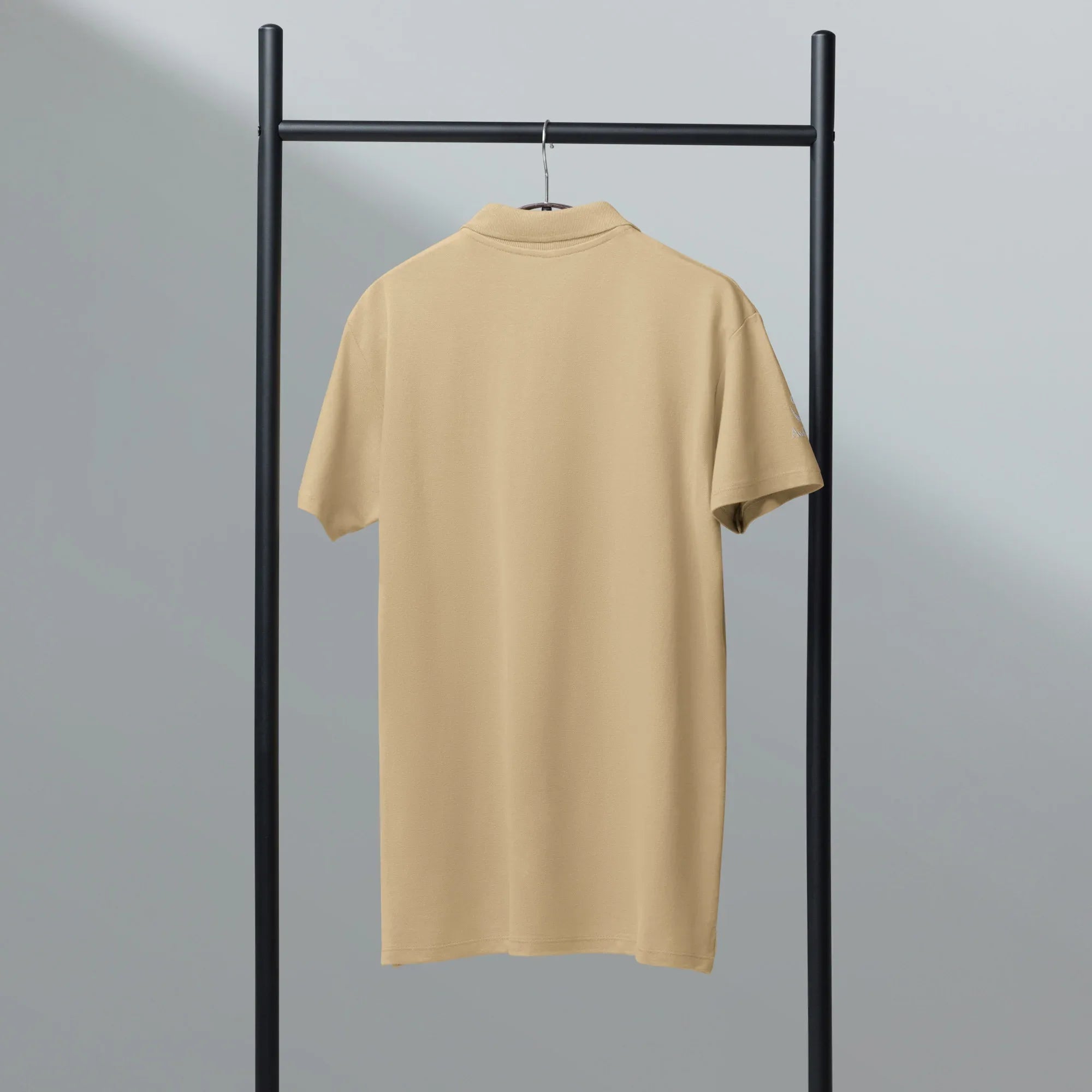 Elegance, effortlessly. Unisex Premium Pique Polo Shirt polo shirt AwRans Clothing unisex-premium-pique-polo-shirt-sand-back-67ba684e6f4d4